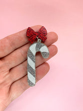 Load image into Gallery viewer, christmas candy cane earringa made from silver glitter toooed with a matching red glitter bow stud