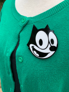 felix the cat brooch on a green cardigan